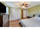 Comfortable bedroom with a double door closet, ceiling fan, and wood-look flooring at 651 W Lake Brantley Rd, Altamonte Springs, FL 32714