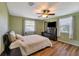 Comfortable bedroom featuring wood floors, a ceiling fan and light, and two windows for plenty of natural light at 651 W Lake Brantley Rd, Altamonte Springs, FL 32714