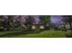 A charming brick house sits on a green lawn, framed by trees under a beautiful evening sky at 651 W Lake Brantley Rd, Altamonte Springs, FL 32714
