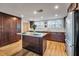 Modern kitchen featuring wood cabinets, stone countertops, stainless steel appliances, and wood flooring at 651 W Lake Brantley Rd, Altamonte Springs, FL 32714