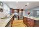 Bright kitchen featuring stainless steel appliances, dark wood cabinets, granite countertops and wood-look floor at 651 W Lake Brantley Rd, Altamonte Springs, FL 32714