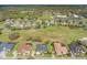 Neighborhood aerial view showing proximity to open green spaces and a golf course at 674 Whisper Woods Dr, Lakeland, FL 33813