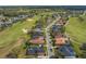 Aerial view of homes on the golf course with lush green fairways and mature trees at 674 Whisper Woods Dr, Lakeland, FL 33813