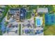 Aerial view of the clubhouse, pool, tennis courts, and parking at 674 Whisper Woods Dr, Lakeland, FL 33813