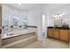 Bathroom featuring a large soaking tub and separate vanity area at 674 Whisper Woods Dr, Lakeland, FL 33813