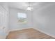 Bedroom featuring wood-look floors, a ceiling fan and a window at 674 Whisper Woods Dr, Lakeland, FL 33813