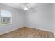 Bright bedroom featuring hardwood floors and ceiling fan at 674 Whisper Woods Dr, Lakeland, FL 33813