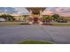 Clubhouse view featuring a covered entrance, brick columns, and golf cart parking at 674 Whisper Woods Dr, Lakeland, FL 33813