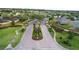 Welcome to the community! Beautifully landscaped entrance with elegant signage and manicured grounds at 674 Whisper Woods Dr, Lakeland, FL 33813