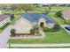 Beautiful home featuring a well-manicured lawn, brick driveway, and lush landscaping at 674 Whisper Woods Dr, Lakeland, FL 33813