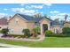 Stunning home showcasing meticulous landscaping, a brick walkway, and tasteful exterior finishes at 674 Whisper Woods Dr, Lakeland, FL 33813