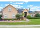 Inviting single-Gathering home with manicured lawn and brick walkway to front entrance at 674 Whisper Woods Dr, Lakeland, FL 33813