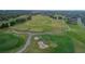 Aerial view of golf course including tee boxes, sand traps, and manicured cart paths at 674 Whisper Woods Dr, Lakeland, FL 33813