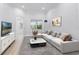Comfortable living room with a plush sofa, stylish decor, and backyard pool view at 674 Whisper Woods Dr, Lakeland, FL 33813