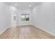 Bright room featuring wood floors and a backyard pool view at 674 Whisper Woods Dr, Lakeland, FL 33813