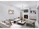 Modern living room with a fireplace, stylish furniture, and plenty of natural light at 674 Whisper Woods Dr, Lakeland, FL 33813