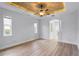 Spacious living room with wood floors, high ceilings, and a ceiling fan at 674 Whisper Woods Dr, Lakeland, FL 33813