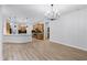 Open-concept living area with wood floors and a view of the kitchen at 674 Whisper Woods Dr, Lakeland, FL 33813