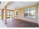Covered patio with brick flooring, ceiling fan, and views of the backyard and screened-in pool at 674 Whisper Woods Dr, Lakeland, FL 33813