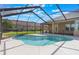 Screened-in pool features a spacious patio and tranquil views at 674 Whisper Woods Dr, Lakeland, FL 33813