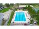 Aerial view of a community pool with many tables and chairs for residents' enjoyment at 674 Whisper Woods Dr, Lakeland, FL 33813