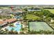 Community featuring a pool, tennis courts, and clubhouse next to a pond at 7853 Summerlake Groves St, Winter Garden, FL 34787