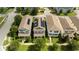 Aerial view of homes with solar panels, manicured lawns, and mature trees at 7853 Summerlake Groves St, Winter Garden, FL 34787