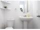 Clean bathroom featuring a pedestal sink, toilet, and minimalist decor at 7853 Summerlake Groves St, Winter Garden, FL 34787