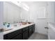 Bathroom features a white sink and vanity, with dark brown cabinets and hardware at 7853 Summerlake Groves St, Winter Garden, FL 34787