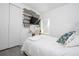 Comfortable bedroom features white bed, accent wall, desk and light gray flooring at 7853 Summerlake Groves St, Winter Garden, FL 34787
