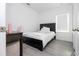 Bright bedroom features a black bed frame, a desk, light grey flooring and large window at 7853 Summerlake Groves St, Winter Garden, FL 34787
