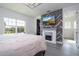 Inviting bedroom featuring a modern fireplace, TV, and spacious layout with ample natural light at 7853 Summerlake Groves St, Winter Garden, FL 34787