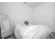 Comfortable bedroom features a white bed with light grey flooring and an accent mirror at 7853 Summerlake Groves St, Winter Garden, FL 34787