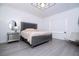 Elegant bedroom featuring a stylish bed, mirrored nightstand, and modern decor at 7853 Summerlake Groves St, Winter Garden, FL 34787