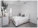 Cozy bedroom features a white bed frame, white bedding, a desk, and light grey flooring at 7853 Summerlake Groves St, Winter Garden, FL 34787