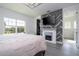 Inviting bedroom featuring a modern fireplace, TV, and spacious layout with ample natural light at 7853 Summerlake Groves St, Winter Garden, FL 34787