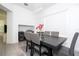 Light and airy dining room with black table and serving bar at 7853 Summerlake Groves St, Winter Garden, FL 34787