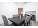 Formal dining room with black table, gray chairs, and modern lighting at 7853 Summerlake Groves St, Winter Garden, FL 34787