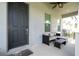 Inviting covered front porch with stylish seating area and view of neighborhood at 7853 Summerlake Groves St, Winter Garden, FL 34787