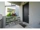 Charming covered front porch with outdoor seating area, plants, and a view of the neighborhood at 7853 Summerlake Groves St, Winter Garden, FL 34787