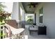 Inviting covered front porch with stylish seating area and view of neighborhood at 7853 Summerlake Groves St, Winter Garden, FL 34787