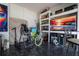 Well organized garage space with mounted tv and shelving at 7853 Summerlake Groves St, Winter Garden, FL 34787