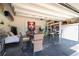 Bright garage with epoxy floors, overhead door and table and chairs at 7853 Summerlake Groves St, Winter Garden, FL 34787