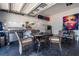 Organized garage space with grill, dining furniture, and colorful wall art at 7853 Summerlake Groves St, Winter Garden, FL 34787