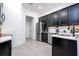 Spacious kitchen featuring stainless steel appliances and sleek black cabinetry at 7853 Summerlake Groves St, Winter Garden, FL 34787