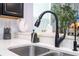 Modern kitchen featuring a sleek black faucet and bright countertops at 7853 Summerlake Groves St, Winter Garden, FL 34787