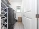 Well-organized laundry room with modern washer and dryer, shelves, and storage baskets at 7853 Summerlake Groves St, Winter Garden, FL 34787