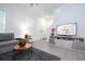 Bright living room boasts neutral tones, a large sectional sofa, and stylish decor for comfortable and modern living at 7853 Summerlake Groves St, Winter Garden, FL 34787