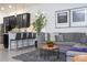Bright living room boasts neutral tones, a large sectional sofa, and stylish decor for comfortable and modern living at 7853 Summerlake Groves St, Winter Garden, FL 34787