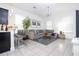 Bright living room boasts neutral tones, a large sectional sofa, and stylish decor for comfortable and modern living at 7853 Summerlake Groves St, Winter Garden, FL 34787